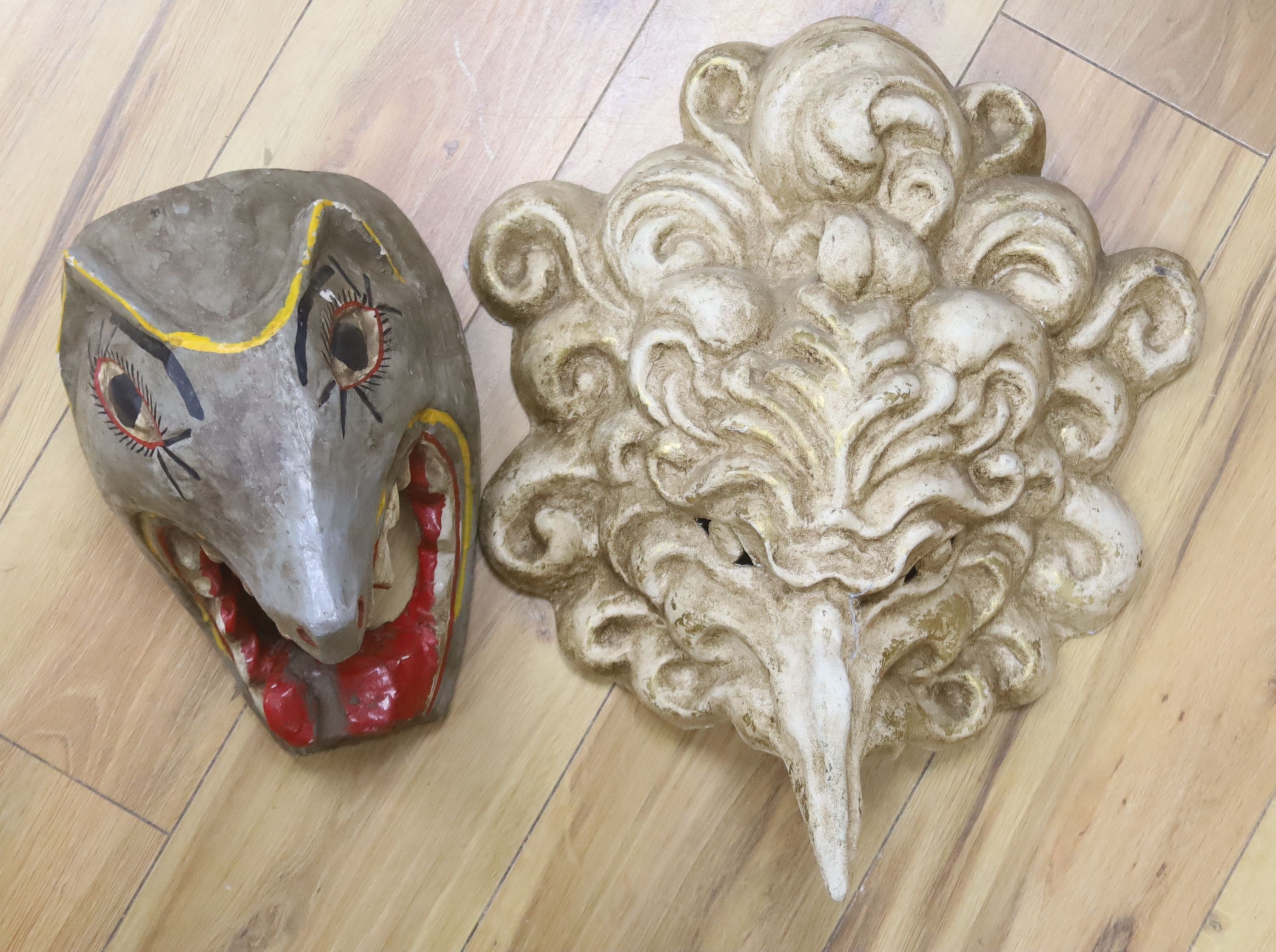 A Venetian gilded papier mache grotesque mask, 46cm, and a painted wood wild animal mask, 13cm